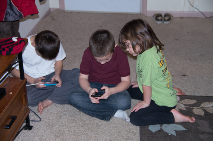 The kids sure enjoy playing with smart phones!