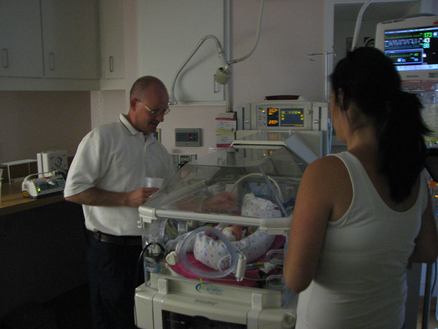 Pastor Tessaro baptizing Caris.