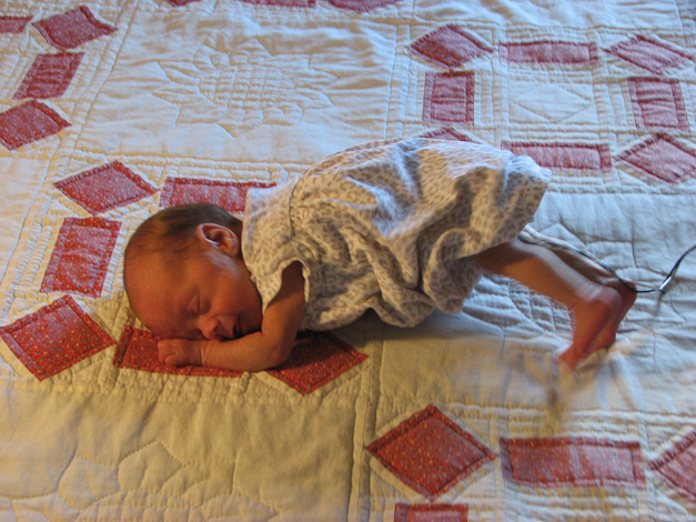 Then we tried photos on the bed with the lovely quilt Richard's mom made. 
